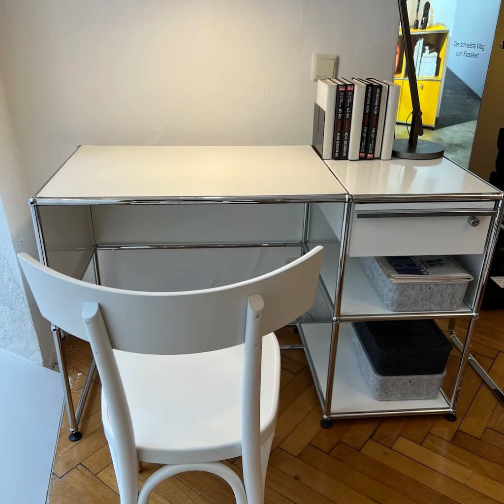 Modular steel desk with drawer module and open shelving in a home office